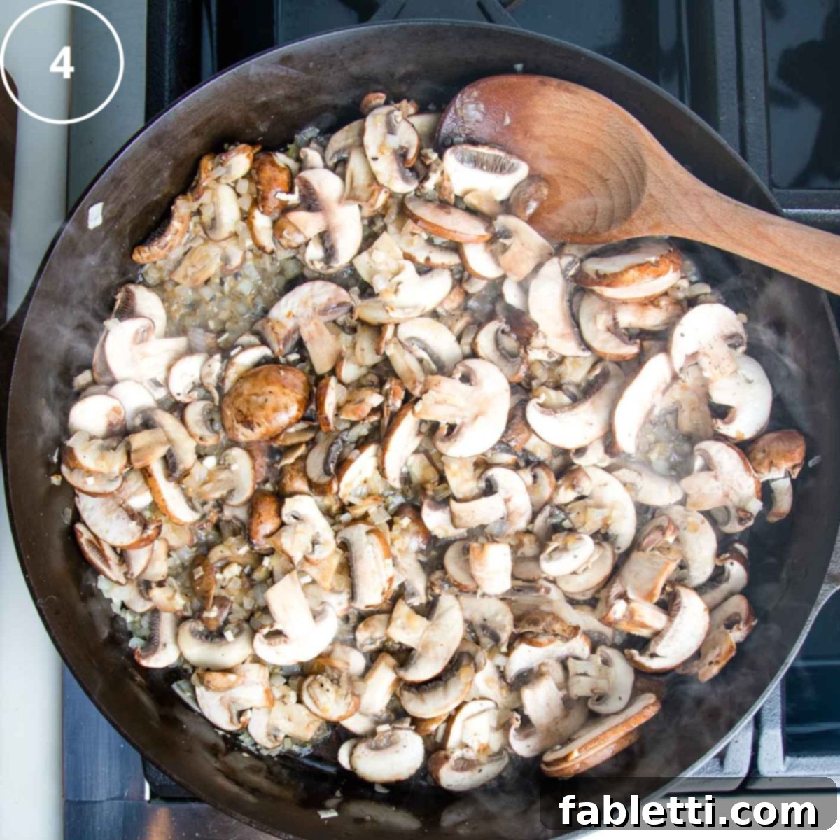Hearty Vegan Mushroom Stroganoff 8 Sliced mushrooms and onions sautéing together in a cast iron skillet, developing rich brown tones.