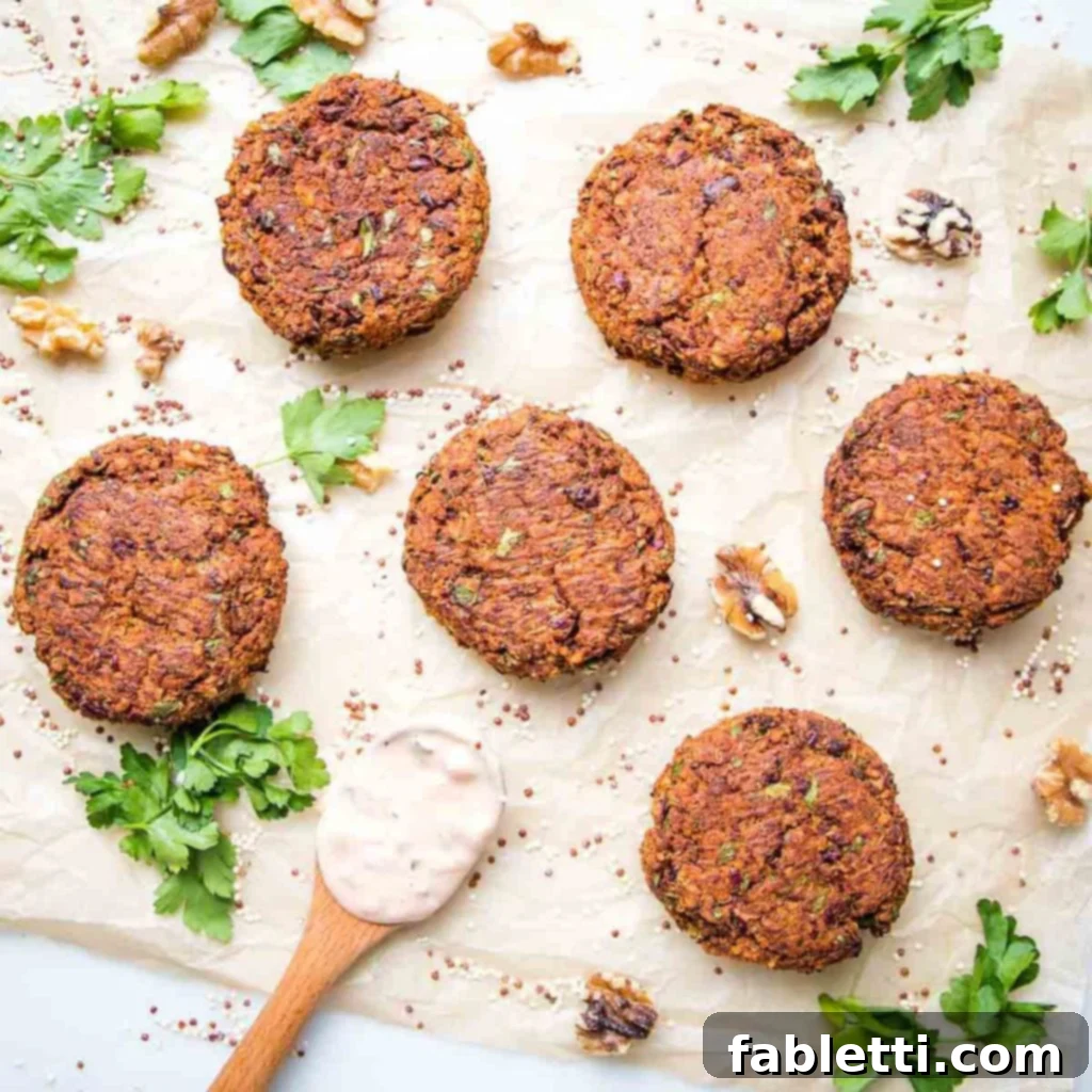 Golden brown quinoa veggie burger patties, artfully arranged with fresh walnuts and vibrant green herbs, showcasing their rustic texture and natural appeal.