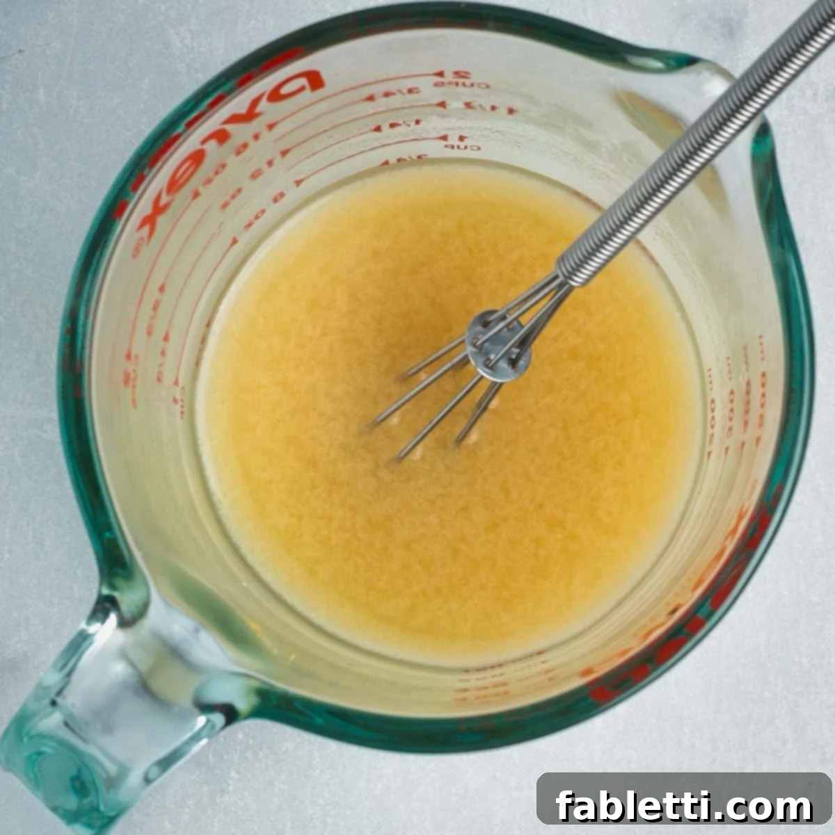 Tangy Vegan Cabbage Soup 11 Whisking the miso paste into hot water.
