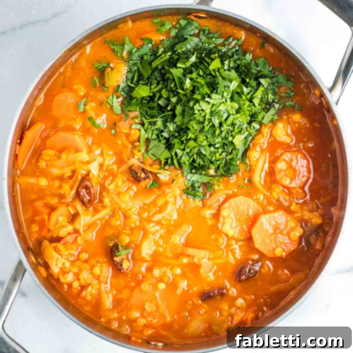 Tangy Vegan Cabbage Soup 13 Adding freshly chopped parsley to the finished cabbage soup.