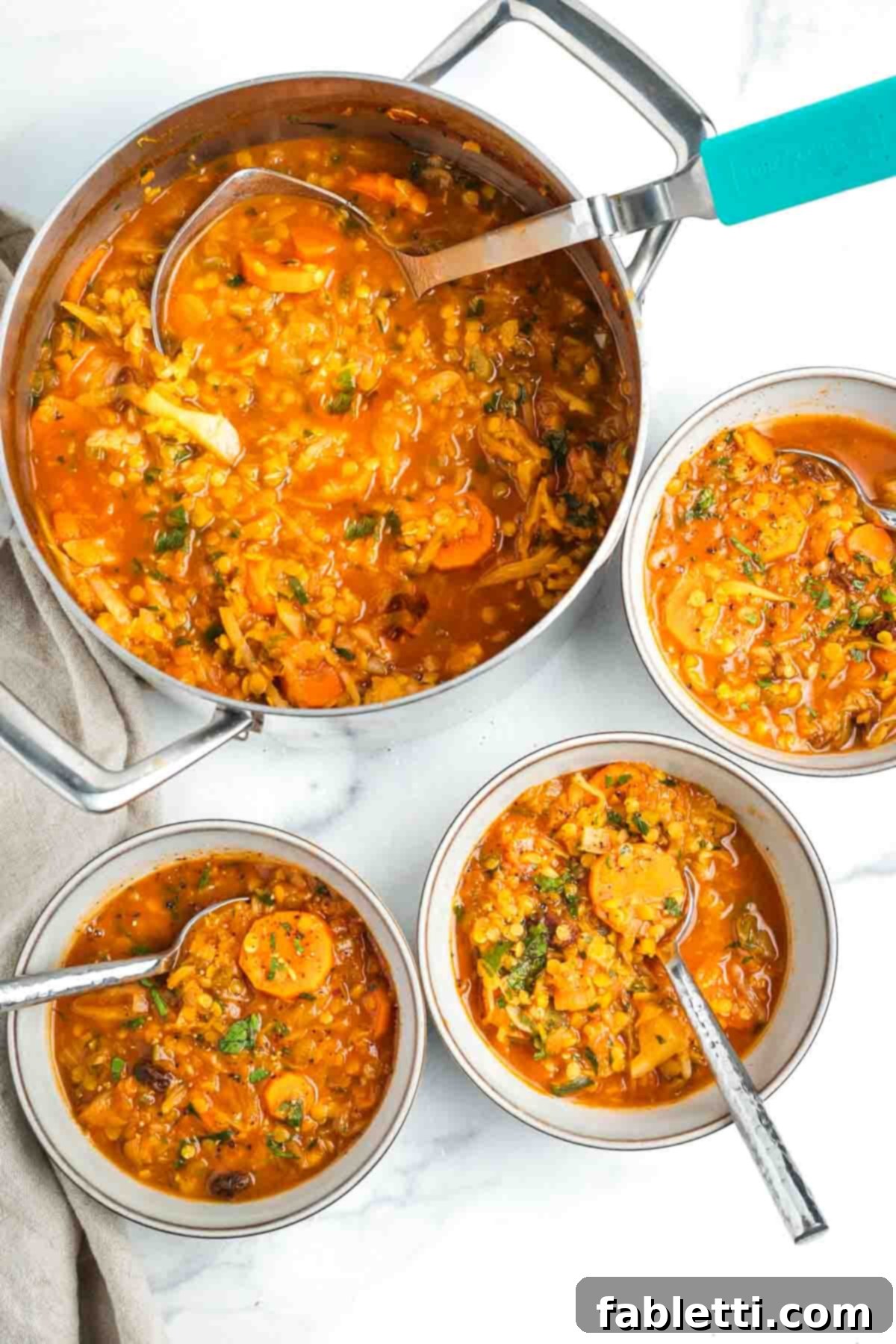 Tangy Vegan Cabbage Soup 16 Ladling the chunky cabbage soup into bowls.