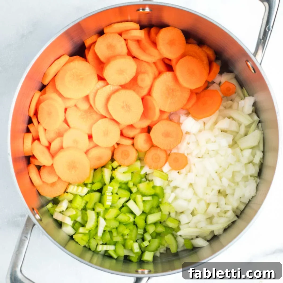 Tangy Vegan Cabbage Soup 4 Sautéing carrots, celery, and onions in a soup pot.