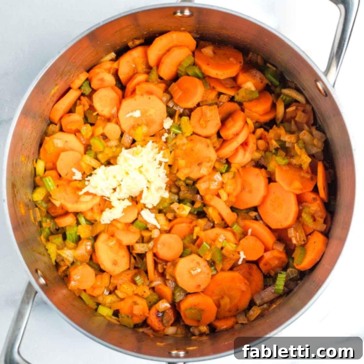 Tangy Vegan Cabbage Soup 6 Minced garlic being added to the sautéed vegetables.