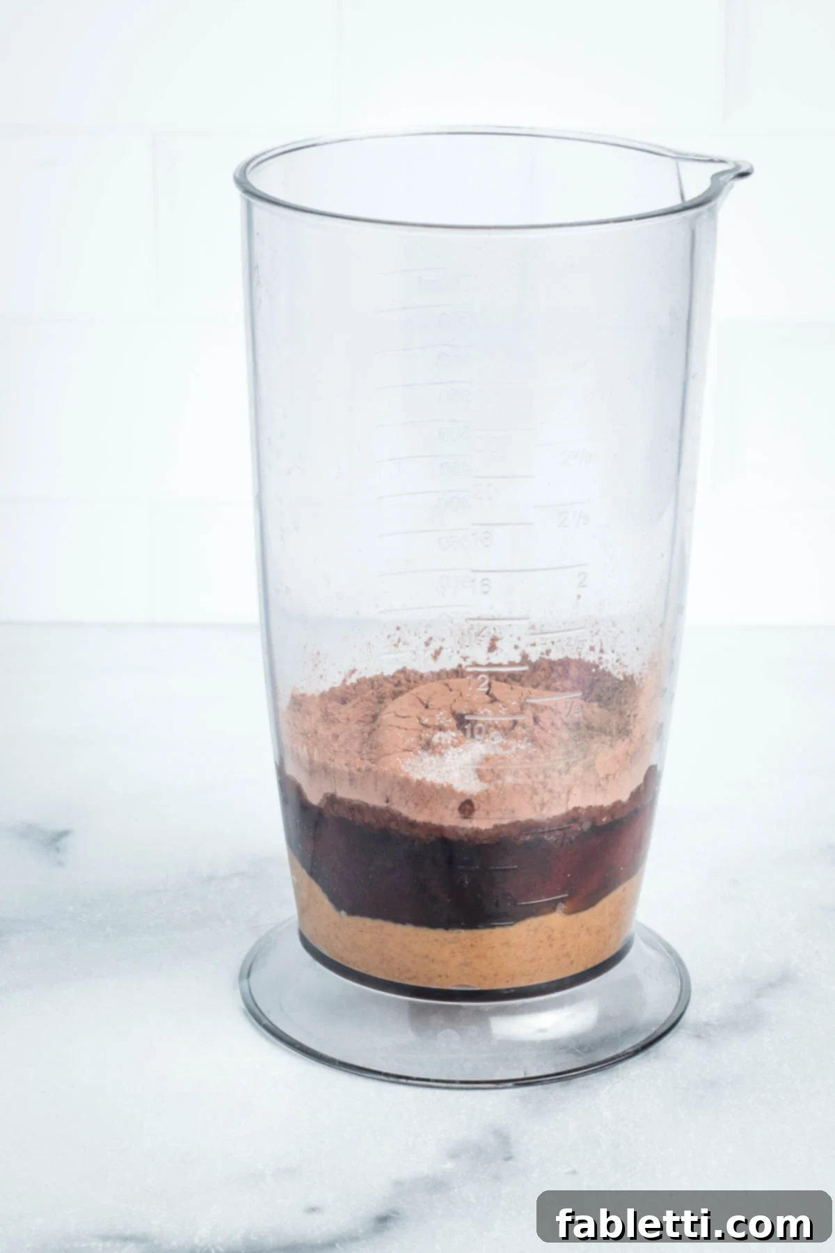 Vegan Flourless Chocolate Cake Delight 13 Ingredients for chocolate frosting in a blender cup