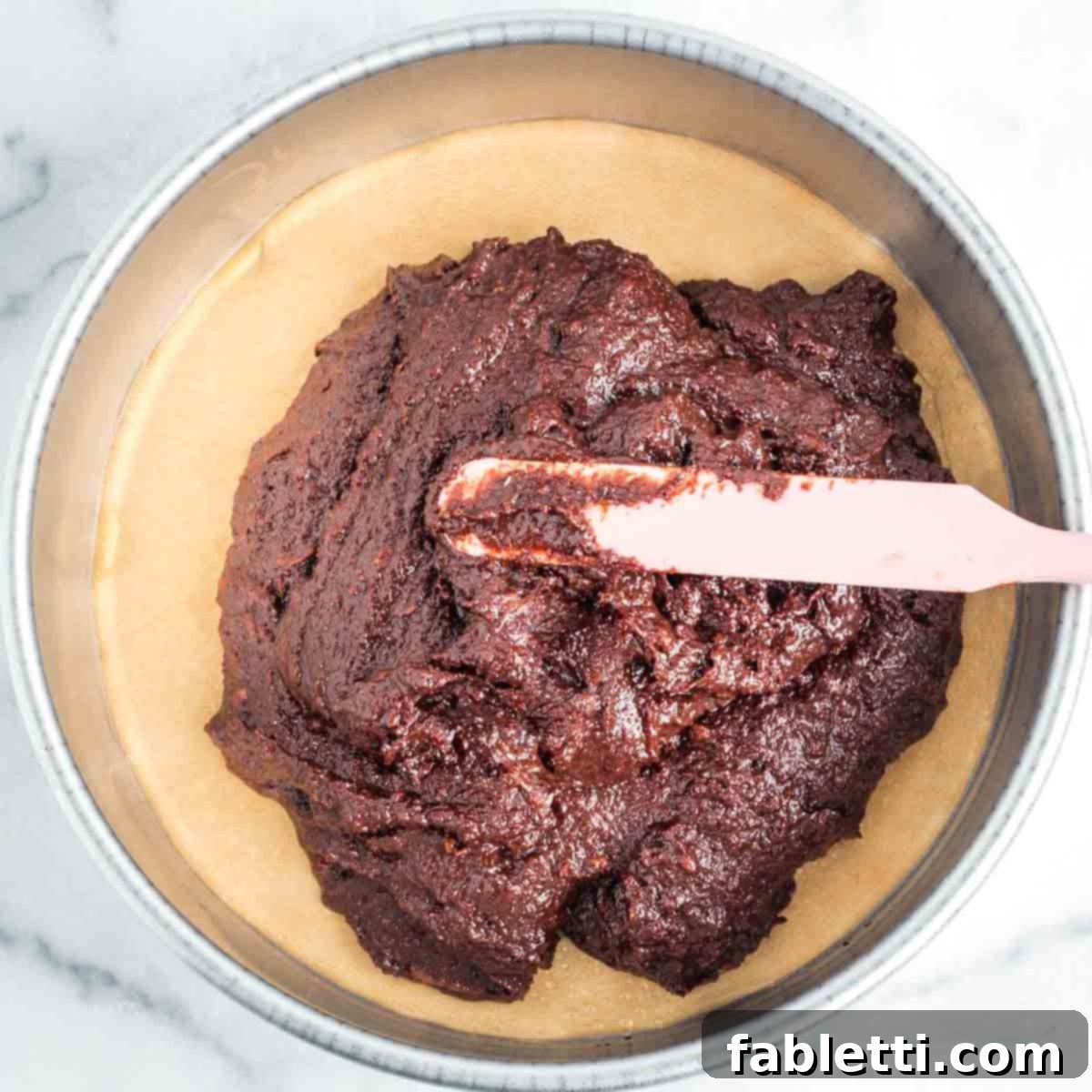 Vegan Flourless Chocolate Cake Delight 10 Spreading chocolate cake batter in a pan