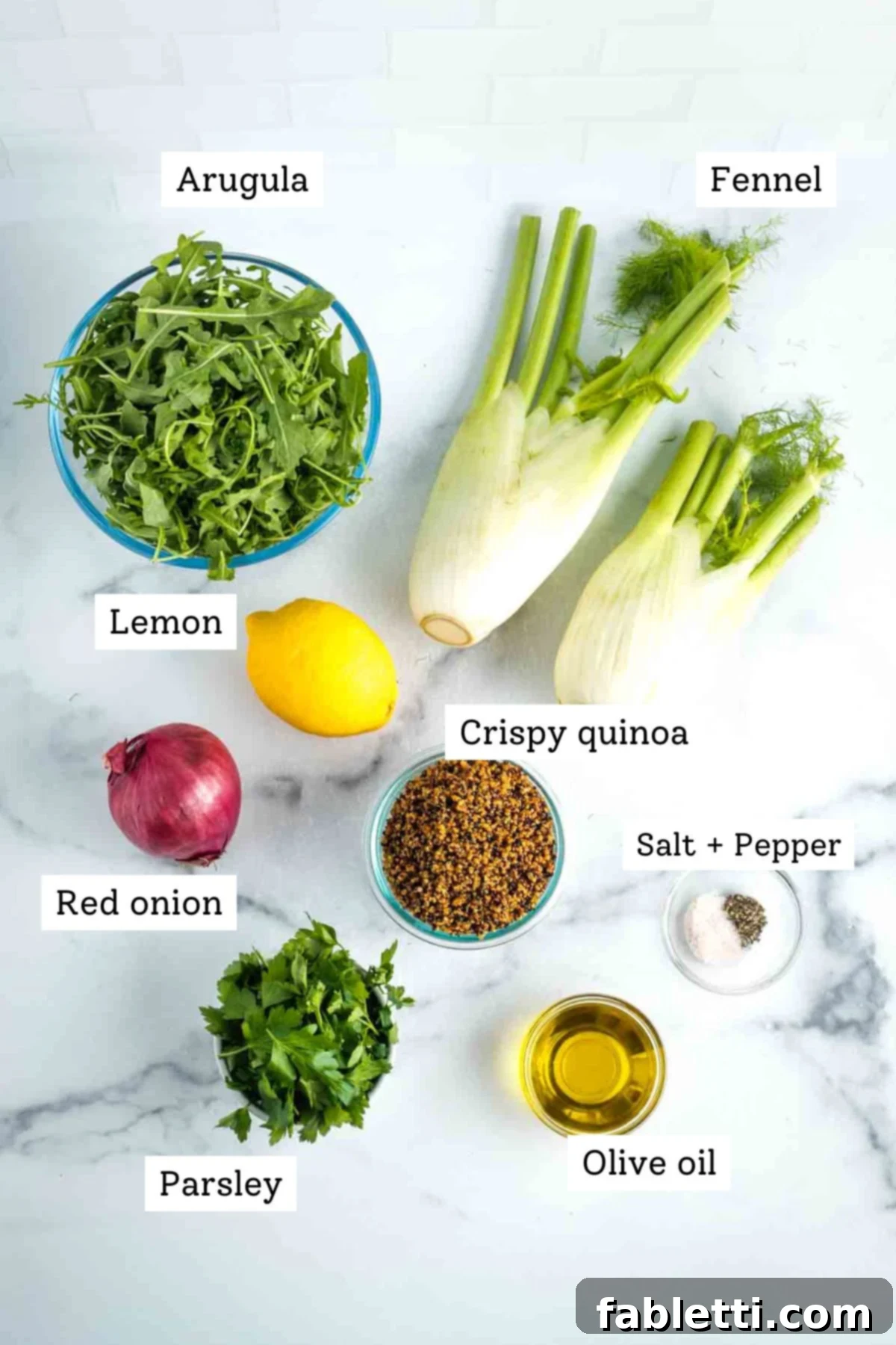 Fennel Arugula Salad with Quinoa Crunch 3 Ingredients labeled: arugula, fennel bulbs, red onion, lemon, parsley, olive oil, salt & pepper, crispy quinoa.