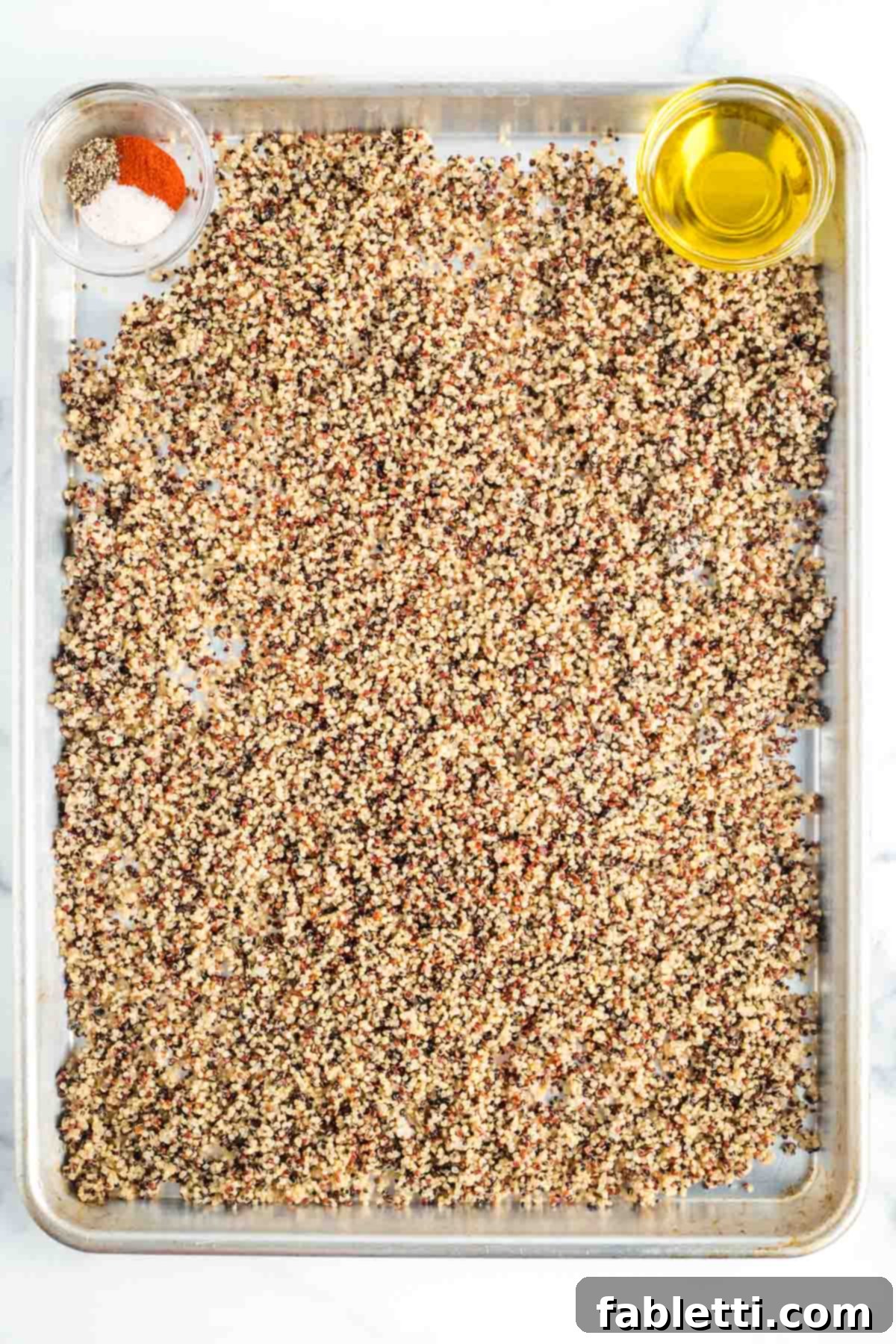 Fennel Arugula Salad with Quinoa Crunch 4 Baking sheet with cooked quinoa, olive oil, paprika, salt, and pepper.