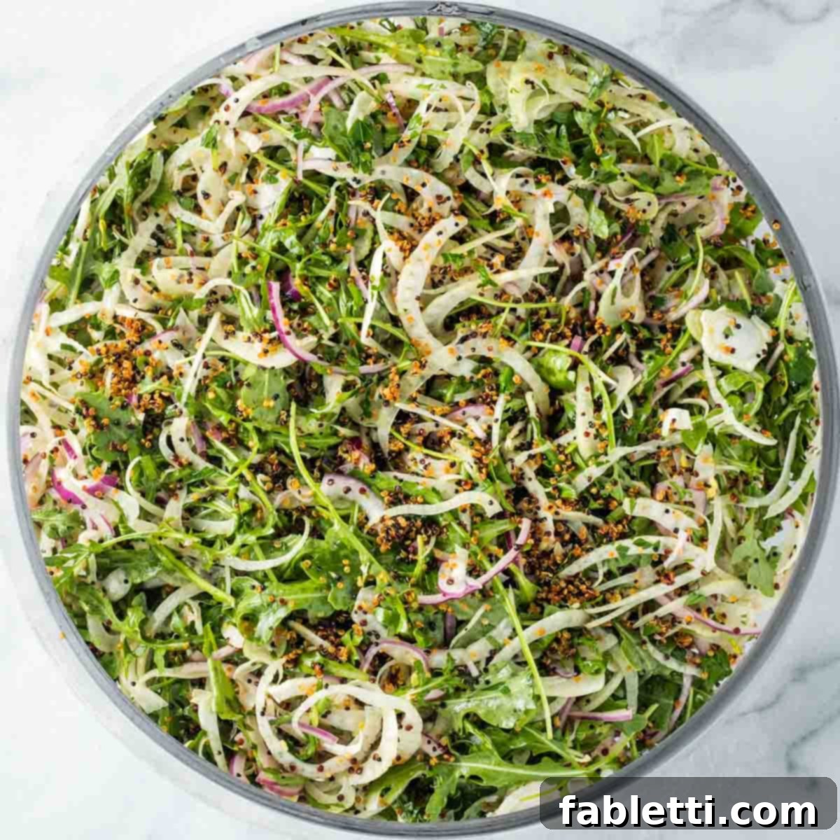 Fennel Arugula Salad with Quinoa Crunch 9 Shaved fennel salad tossed with arugula, onion, and crispy quinoa.